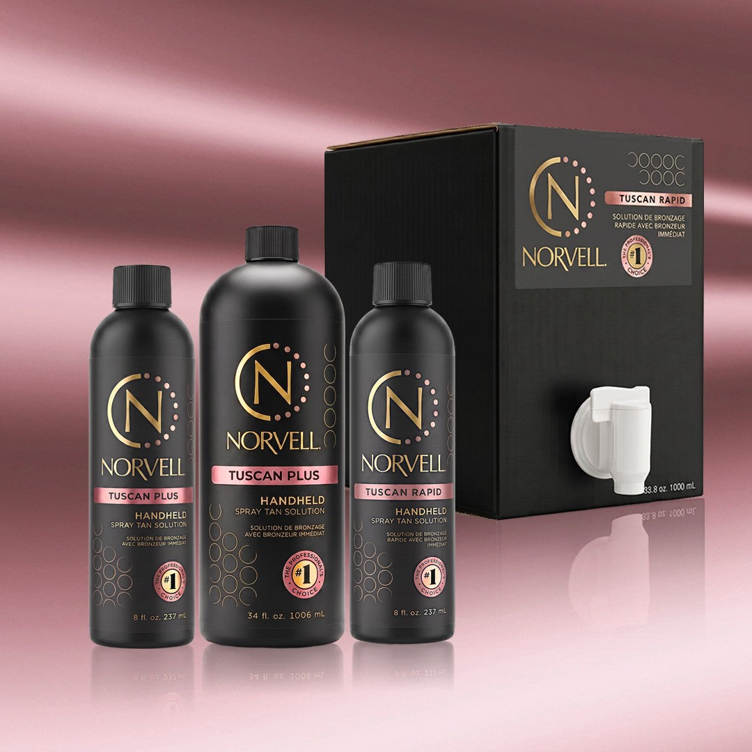 Norvell Tuscan Rapid and Tuscan Plus tanning products on a reflective surface with a rose gold background.