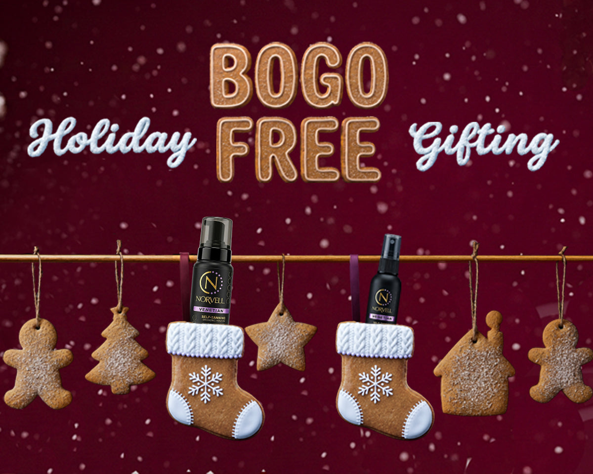 Norvell holiday gifting banner reading “BOGO FREE,” with tanning products in gingerbread stockings against a festive red background.