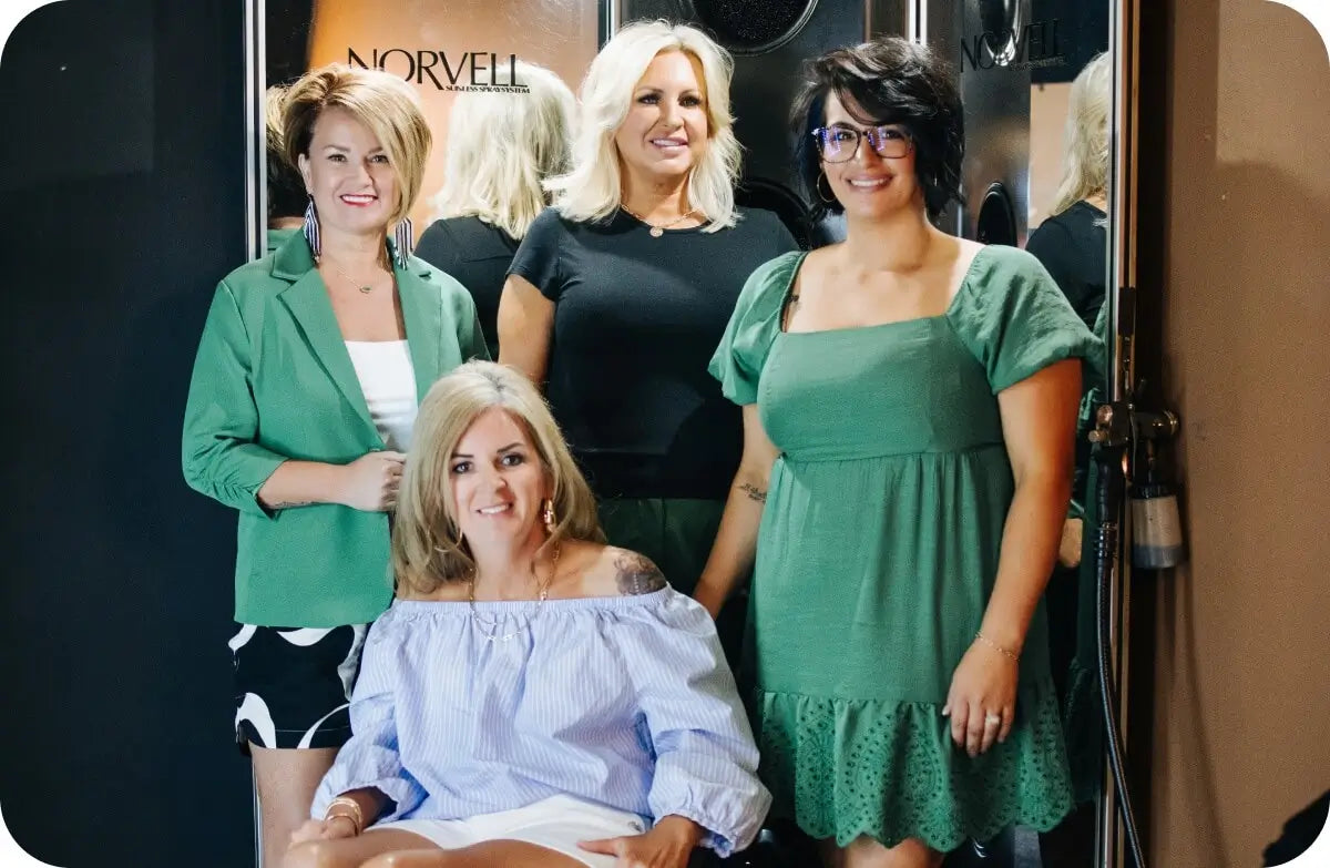 A group of professional Norvell educators and cosmetology school partners posing together at a training event.